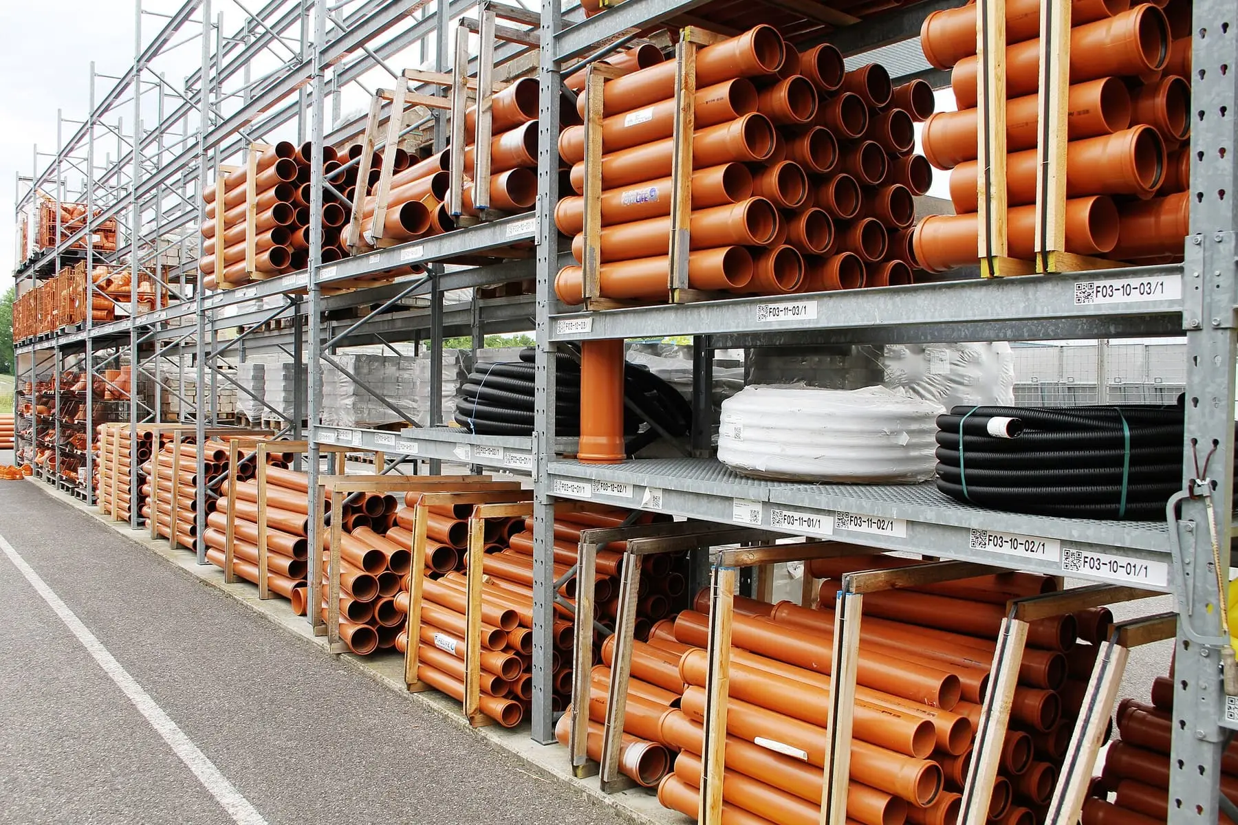 Racked pallets in a distribution warehouse under high bay lighting.